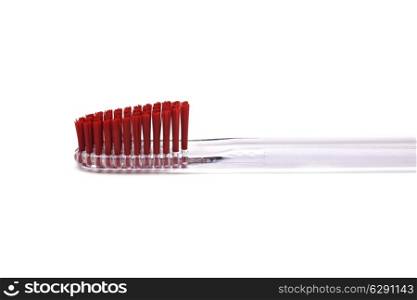 red toothbrush isolated on white background close up