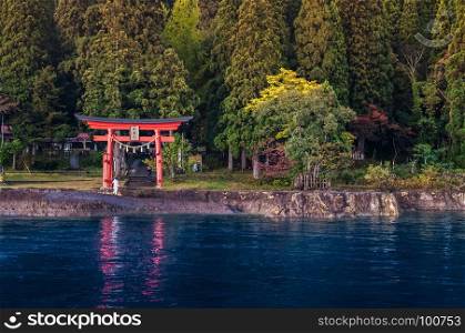 Red Torii of Shrine at Lake Tazawa ko, Senboku, Akita, Japan.