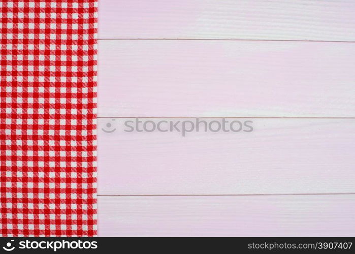 Red towel over wooden kitchen table. View from above.