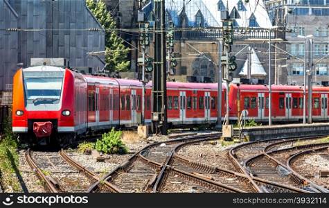 red train depart frim the station Cologne Germany.