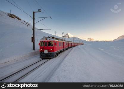 Red train during the passage of the Bernina pass areas