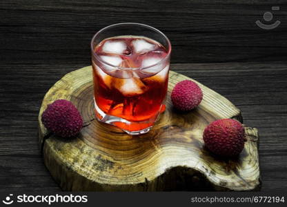 Red tropical alcoholic cocktail with lychees and ice.