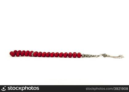 Red Turkish rosary isolated on white under studio lighting