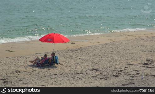 Red umbrella on Ho Hum beach on Fire Island