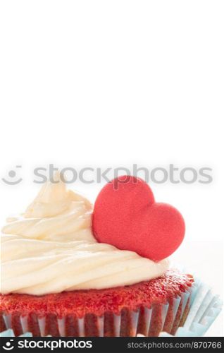 Red velvet heart cupcake with cream cheese frosting and a red heart for Valentine's Day. Isolated on white background with copy space.