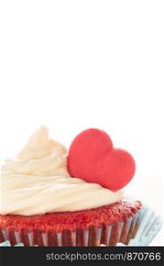 Red velvet heart cupcake with cream cheese frosting and a red heart for Valentine's Day. Isolated on white background with copy space.