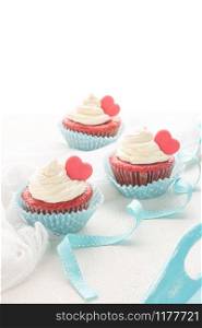 Red velvet heart cupcakes with cream cheese frosting and a red heart for Valentine&rsquo;s Day. Top view with copy space