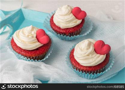Red velvet heart cupcakes with cream cheese frosting and a red heart for Valentine's Day