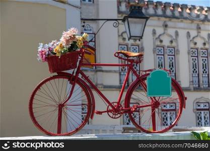 Red Vintage Bicycle with Colorful Flowers in the Basket in Sintra, Portugal