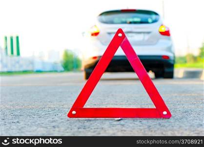 red warning triangle and a car with the emergency alarm
