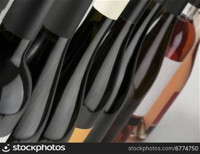 Red white and rose wine bottles in a row