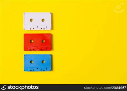 red white blue audio cassette tape yellow background