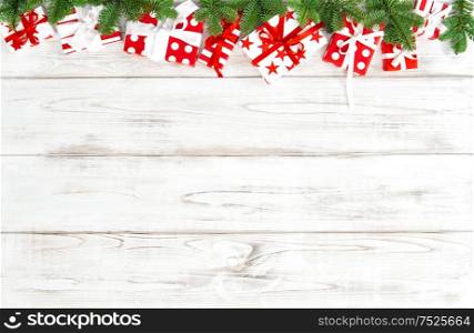 Red white gift boxes with ribbon bow. Christmas decoration on bright wooden background