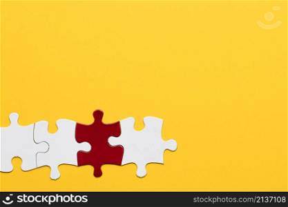 red white puzzle piece with yellow background