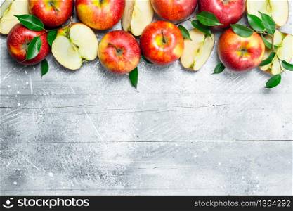 Red whole apples and Apple slices. On white rustic background.. Red whole apples and Apple slices.