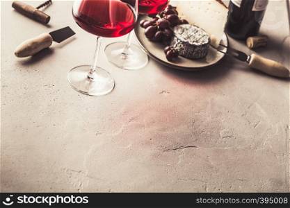 Red wine and cheese on concrete background, copyspace. Red wine and cheese on concrete background