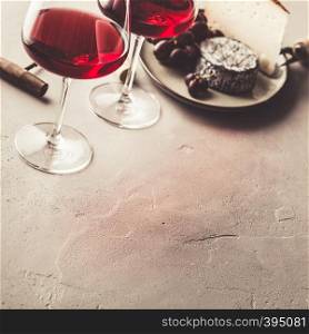 Red wine and cheese on concrete background, copyspace. Red wine and cheese on concrete background