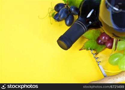Red wine and fresh grape on yellow background