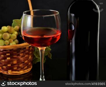 red wine and grape on black background