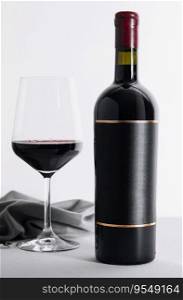 Red wine and wine bottle on stone