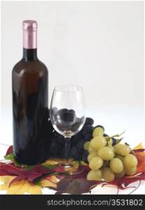 Red wine bottle, glass and grapes