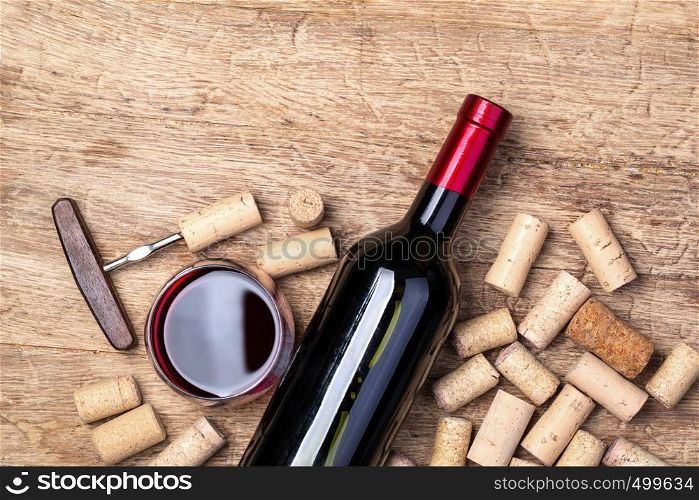 red wine bottle on wooden table top view