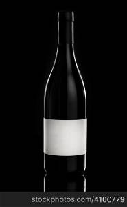 Red wine bottle over a black background with empty label