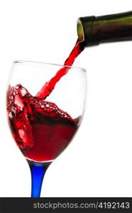 Red wine flowing from a green bottle to a glass. All is isolated with a clipping path