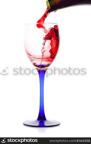 Red wine flowing from a green bottle to a glass.Isolated on white