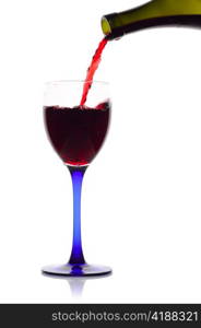 Red wine flowing from a green bottle to a glass.Isolated on white