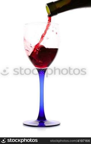 Red wine flowing from a green bottle to a glass.Isolated on white