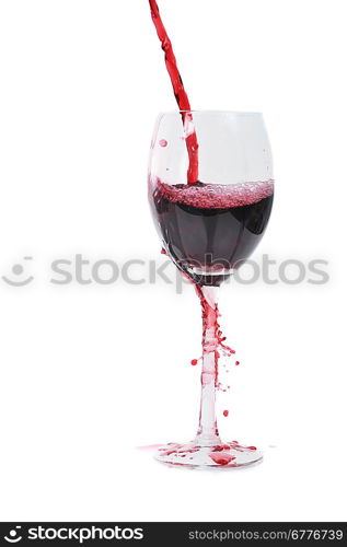 Red wine flowing in transparent glass