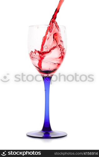 Red wine flowing to a glass. Isolated on white
