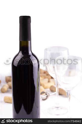 Red wine glasses, bottle and corks. Isolated on white background