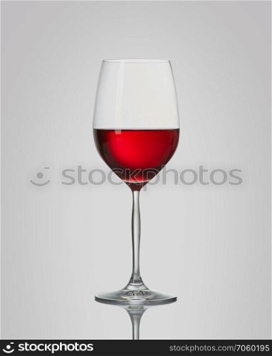 red wine in a glass isolated on a gray background. Red wine in a glass isolated