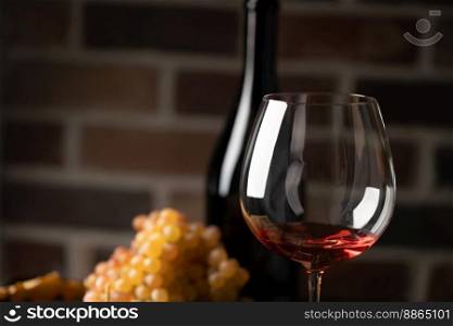 Red wine in a glass with fall grapes, dark rustic background, winery concept.. Red wine in a glass