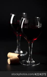 red wine in glasses and corks