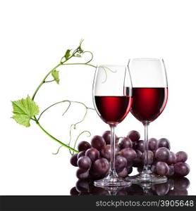 Red wine in glasses with grape and rod isolated on white