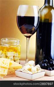 Red wine in wineglass cheese and olives