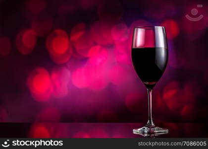 Red wine in wineglass on bokeh background. Red wine on bokeh background