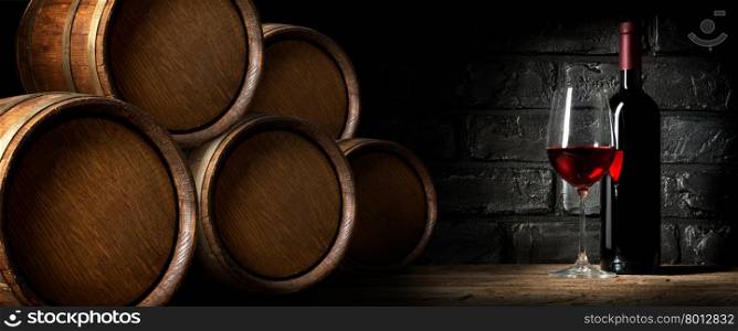 Red wine near barrels in cellar of winery
