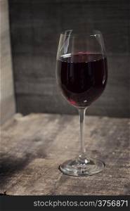 Red wine on old wooden table
