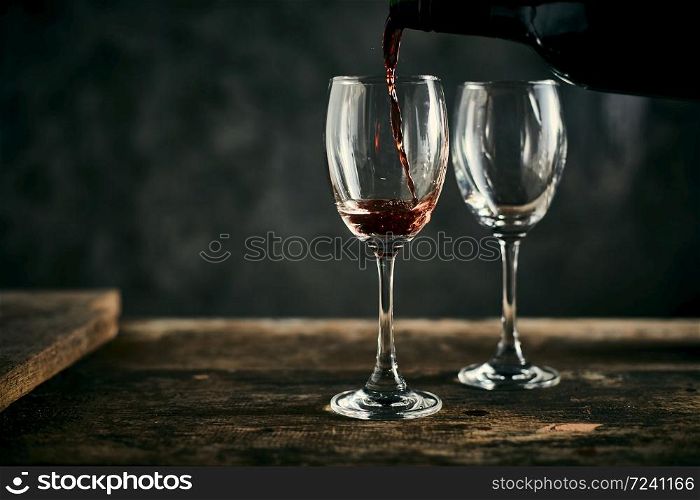 Red wine on wood background.