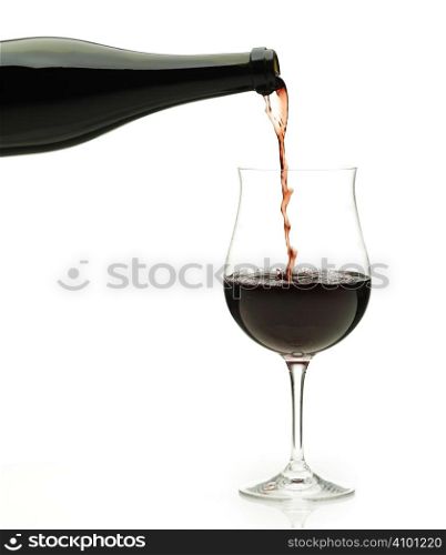 Red wine pouring down from a wine bottle