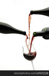 Red wine pouring down from a wine bottles