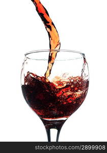 Red wine pouring in glass. Isolated over white