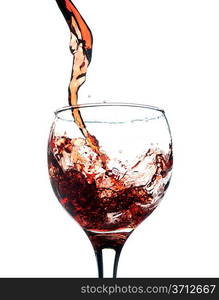 Red wine pouring in glass. Isolated over white