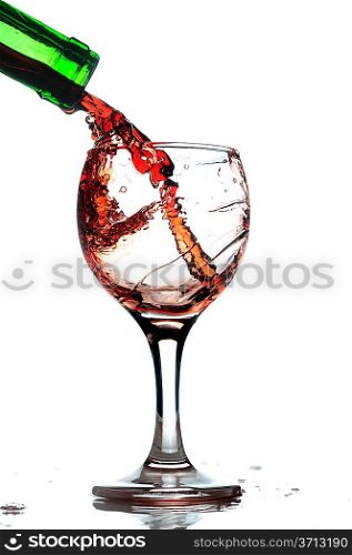 Red wine pouring in glass. Isolated over white