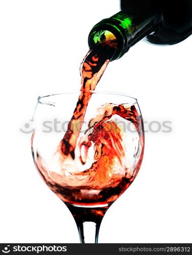 Red wine pouring in glass. Isolated over white. Focused on bottle.