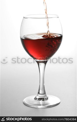 red wine pouring into glass